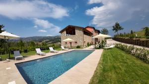 a villa with a swimming pool and a house at Agriturismo Monte di Bebbio in Bebbio