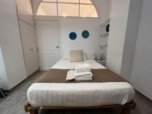 a bedroom with a large bed with towels on it at Budget-friendly 1BR in the city center in Gibraltar