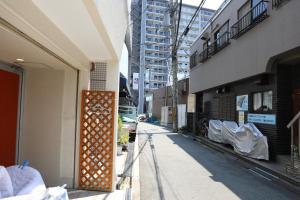 an empty street in a city with buildings at Private house YOURSとなり in Osaka