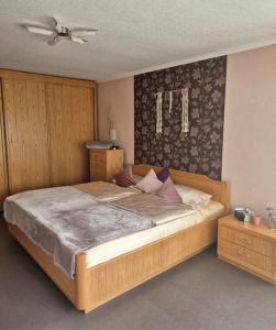 a bedroom with a large bed and a ceiling fan at Ferienwohnung Grüne Auszeit in Nideggen