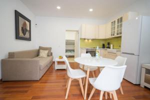 a kitchen and a living room with a table and chairs at Casa Rural da Eva in Santa Cruz de Tenerife