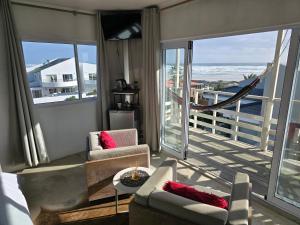 a living room with a view of the ocean at Atlantic Loft - Open plan apartment with Sea Views in Melkbosstrand