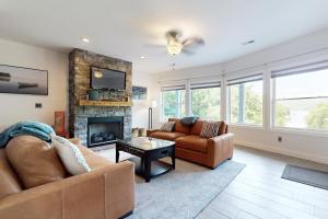 a living room with two couches and a fireplace at Lake Norris Epic Aqua Haven in Maynardville