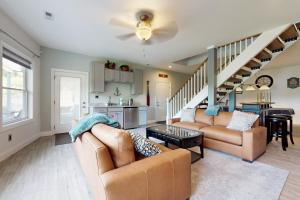 a living room with two couches and a staircase at Lake Norris Epic Aqua Haven in Maynardville