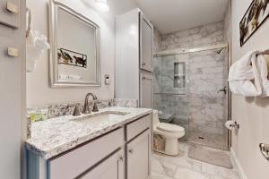 a bathroom with a sink and a toilet and a shower at Lake Norris Epic Aqua Haven in Maynardville +45 photos