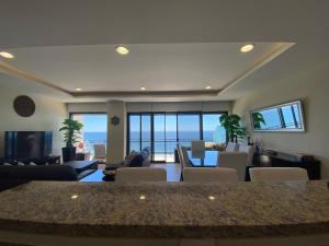 a living room with a view of the ocean at Pearl Tower Condo in Mazatlán