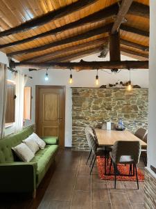 a living room with a green couch and a table at Quinta da Meda in Coimbra
