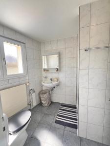 a bathroom with a toilet and a sink at Ferienwohnung SUN SAND SEA in Horn