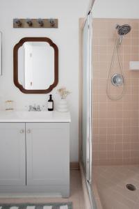 a bathroom with a white sink and a mirror at Peaceful, modern, renovated, close to everything! in Gainesville +20 photos