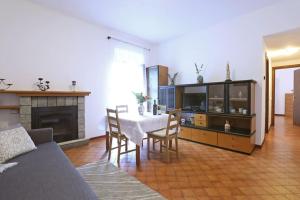 a living room with a table and a fireplace at Casa del pescatore e Mary! in Mezzegra
