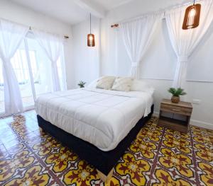 Postel nebo postele na pokoji v ubytování Puesta del Sol Guest House