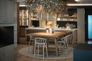a kitchen with a wooden table and chairs at Hotel Petrus in Brunico