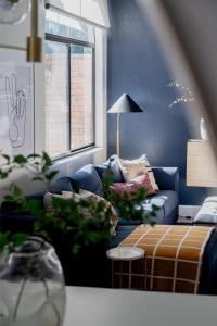 a living room with a couch and a table at Quiet, convenient & Modern Haven in Gainesville
