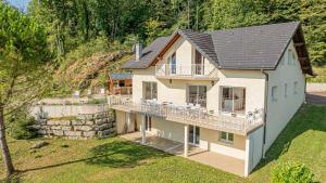 an aerial view of a house with a balcony at Villa Panoramique - Lac du Bourget in Bourdeau