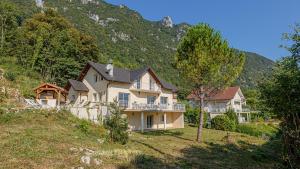 a large house on a hill in the mountains at Villa Panoramique - Lac du Bourget in Bourdeau