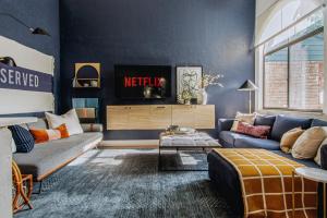 a living room with a couch and a tv at Quiet, convenient & Modern Haven in Gainesville
