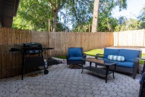 a patio with two chairs and a table and a fence at Quiet, convenient & Modern Haven in Gainesville