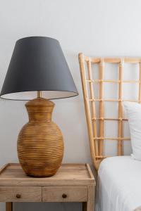 a lamp sitting on a table next to a bed at Quiet, convenient & Modern Haven in Gainesville