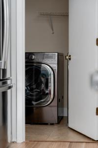 a silver washer and dryer in a room at Quiet, convenient & Modern Haven in Gainesville