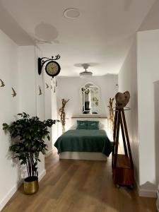 a bedroom with a bed and a clock on the wall at La Casa de la Abuela in Jaén