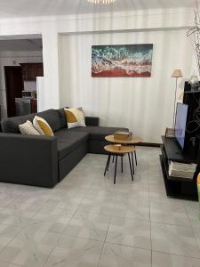 a living room with a couch and a table at Apartamento F.A in Pedrógão +5 photos