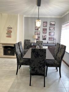 a dining room with a table and chairs and a fireplace at Apartamento F.A in Pedrógão
