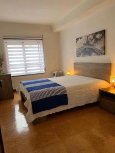 a bedroom with a bed and a window at Apartamento F.A in Pedrógão