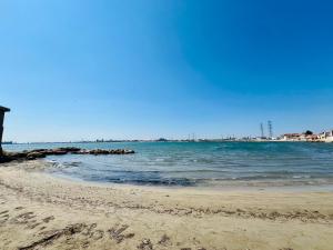 a beach with the ocean and rocks in the water at Coeur de Fos-Centre Ville-CLIM-Plages-Parking-4 personnes in Fos-sur-Mer