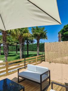 a white couch sitting under a large white umbrella at Natura Resorts in Casalarreina