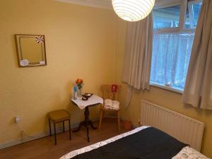 a bedroom with a bed and a table and a mirror at Kilmactrasna Cottage in Carrickmacross