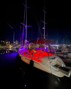 a boat is docked in the water at night at Carranade yacht in Torquay