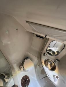 a small bathroom with a toilet and a sink at Carranade yacht in Torquay +7 photos