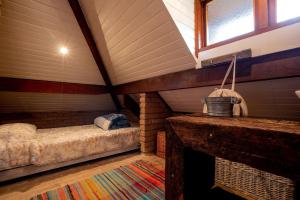 a room with a bed in a attic at Design Home by The Lodges in Campos do Jordão