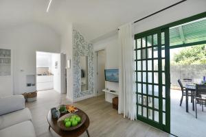 a living room with a couch and a table at Cozy Bungalow Playa Flor Maspalomas by VillaGranCanaria in Maspalomas