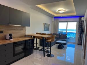 a kitchen with a table and a living room at Poseidon 4 in Paralia Katerinis