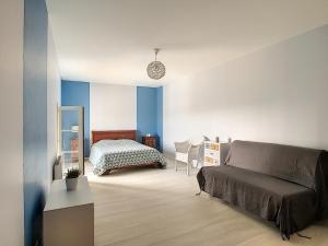 a bedroom with a bed and a mirror at Les Caboches de Garanche in Charentay