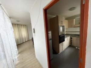 a kitchen with a door open to a room at Edificio INMOBILIA - Av Argetina 2 dormitorios in Antofagasta +36 photos