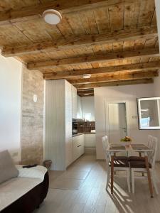 a living room with a table and a kitchen at Lake house Zoya in Nikšić