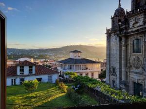 an old building with a view of a city at O Picho: apartamento céntrico. in Puentedeume