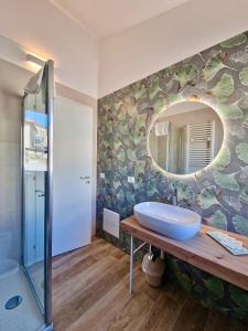 a bathroom with a sink and a mirror at Casa Adelina by TraMonti Apartments in Poggio Picenze