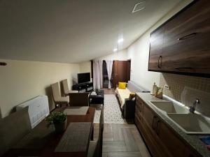 a kitchen and living room with a couch and a table at Retreat in the centre of Korce in Korçë +29 photos