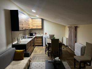 a kitchen and living room with a couch and a table at Retreat in the centre of Korce in Korçë
