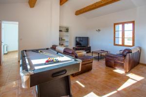 a living room with a pool table and couches at Villa Les Juliannes by Villa Plus in Azillanet