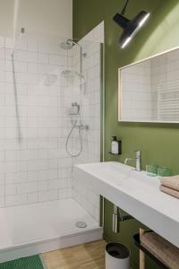 a bathroom with a shower and a sink at Great to stay Gent I rooms & apartments in Ghent +49 photos