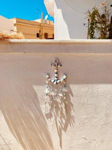 a bunch of beads hanging on a wall at Porto Levante Anemos in Ermoupoli