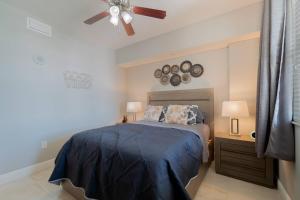 a bedroom with a bed and a ceiling fan at The Relaxing Oasis Suite - Casa Costa 201S 1 Bedroom, Pools, Jacuzzi, Beach, Shops & Dog Friendly in Boynton Beach +42 photos