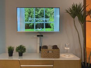 a window with the word recounting on it in a room with plants at MoonDal Stay in Busan