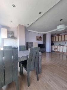 a kitchen with a dining room table and chairs at Apartment Rozen in Varna City