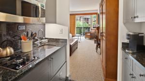 a kitchen with a sink and a counter top at 319 Lodge At Spruce Peak Ski In Ski In Ski Out King Studio By Stowe Mountain Rentals in Stowe