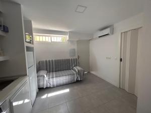 a living room with a couch and a window at Apartamentos Yiya in Málaga